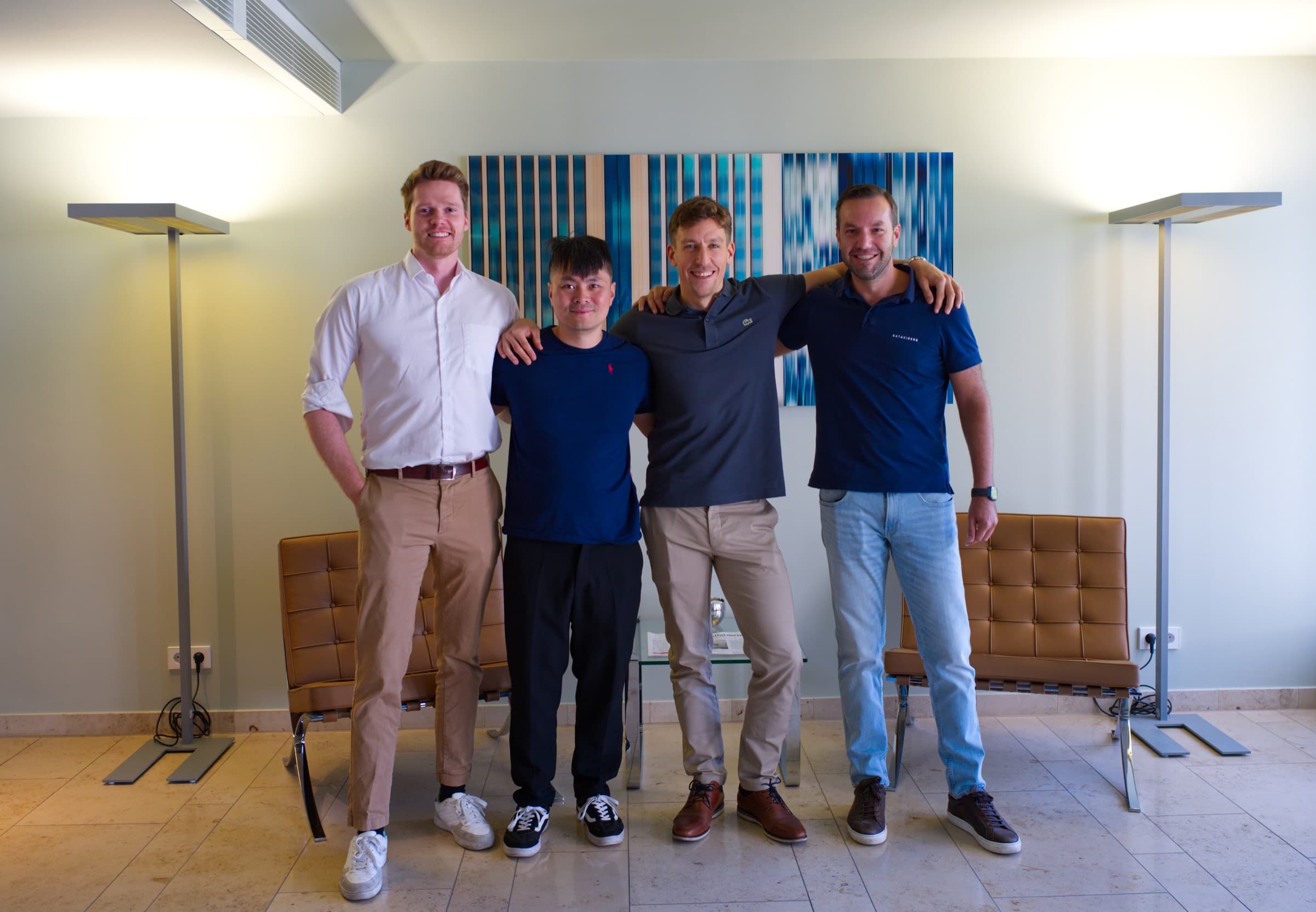 DATANOMIQ and Dataciders teams standing together after the announcement